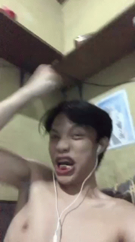 Man Shirtless Wearing Headphones Making Funny Face