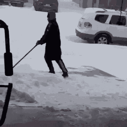 Man Shoveling Snow in Front of White SUV