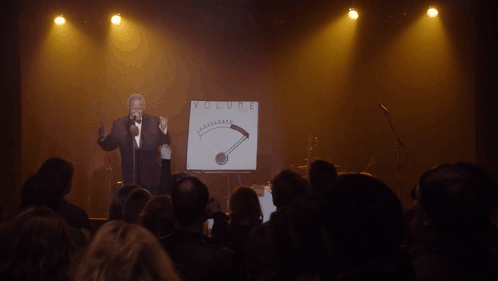 Man Singing Into Microphone At Volume Sign GIF
