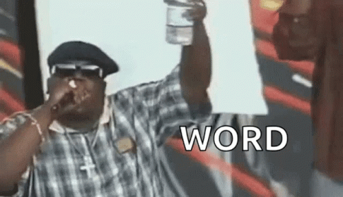 Man Singing Into Microphone Holding Water Bottle and Word Sign