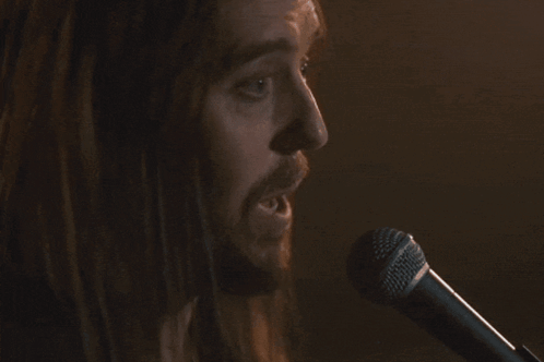 Man Singing Into Microphone I Do Not Cope Well With Unresolved Things