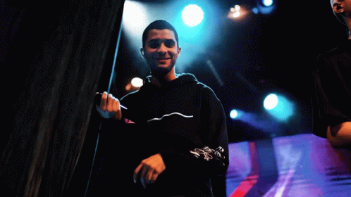 Man Singing Into Microphone in Black Hoodie
