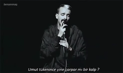 Man Singing Into Microphone in Dark