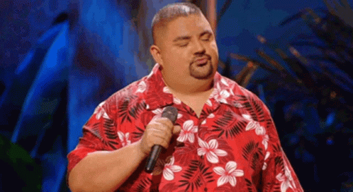 Man Singing Into Microphone in Red Hawaiian Shirt