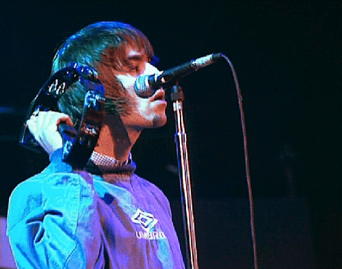 Man Singing Into Microphone in Umbro Jacket