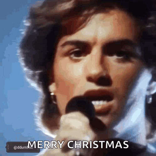 Man Singing Into Microphone Merry Christmas