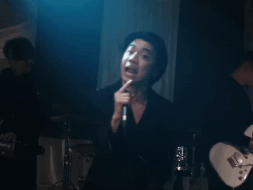 Man Singing Into Microphone Mouth Open