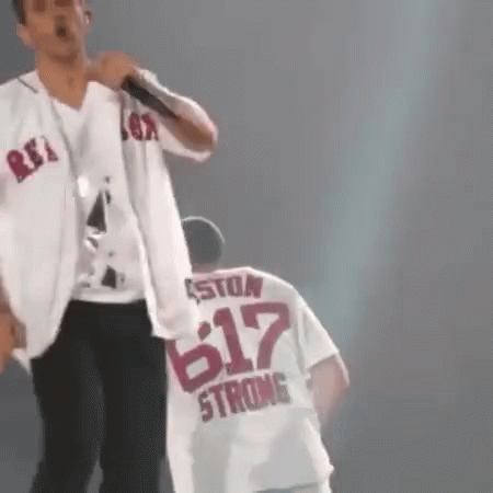 Man Singing Into Microphone Next to Man in 617 Shirt