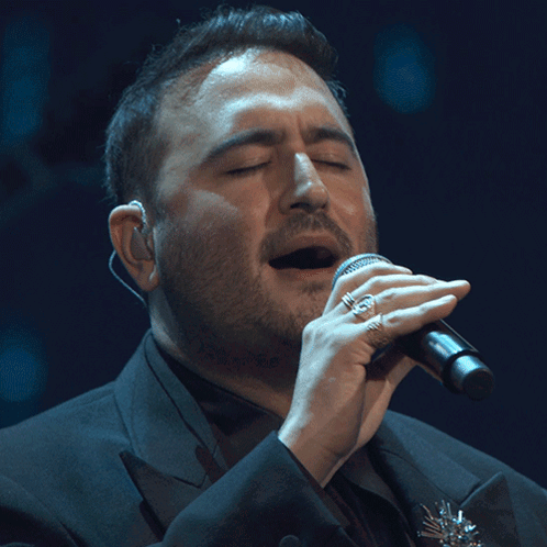 Man Singing Into Microphone