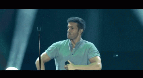 Man Singing Into Microphone Thumbs Up