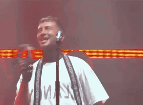 Man Singing Into Microphone White Shirt Maj3