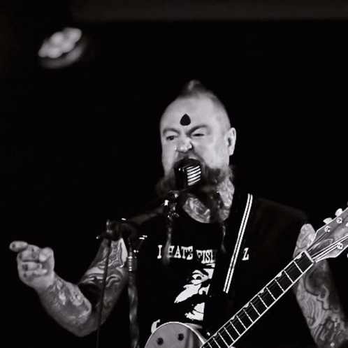 Man Singing Into Microphone With I Hate This Z Shirt