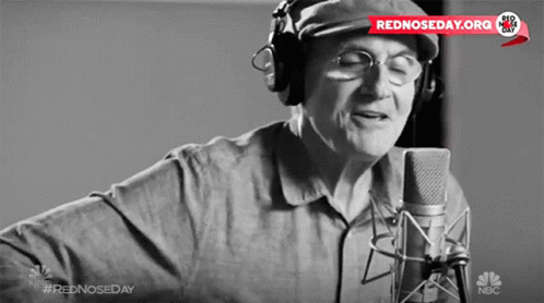Man Singing Into Microphone With Rednosedday.org Sticker