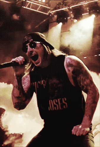 Man Singing Into Microphone With Roses Shirt GIF