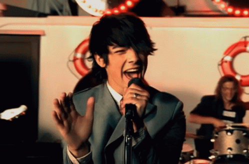 Man Singing Into Microphone With Tongue Out GIF