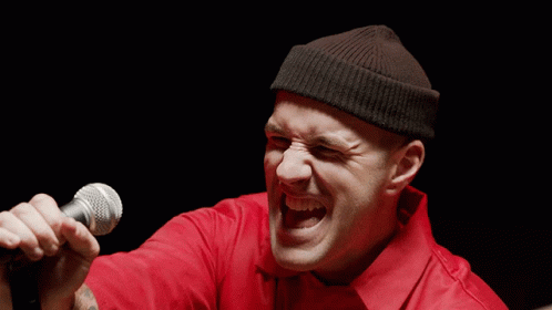 Man Singing Microphone in Red Shirt Black Beanie