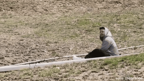 Man Sits on White Object With Number 3000