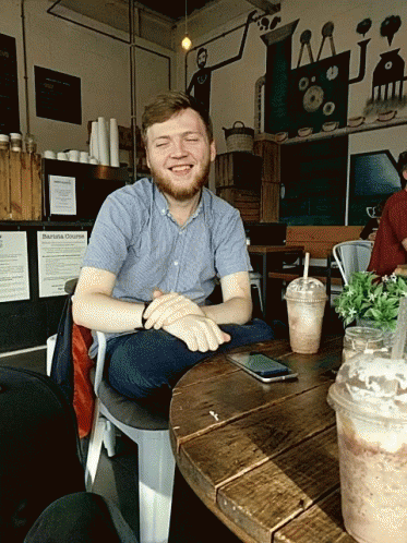 Man Sitting At Barista Chronicles Sign GIF