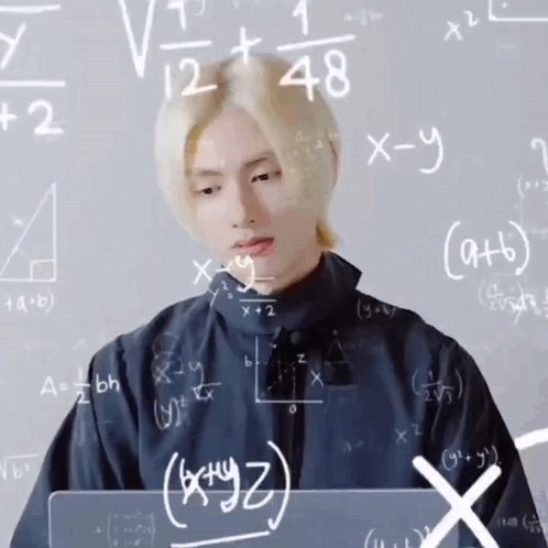 Man Sitting at Chalkboard With Math Equations