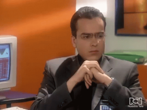 Man Sitting At Computer With Nuestra Tele Shirt GIF