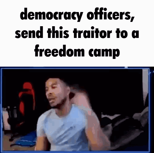 Man Sitting at Computer With Text Democracy Officers Send This Traitor to a Freedom Camp