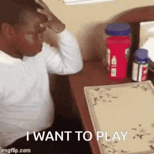 Man Sitting At Desk Hand On Head Saying I Want To Play GIF