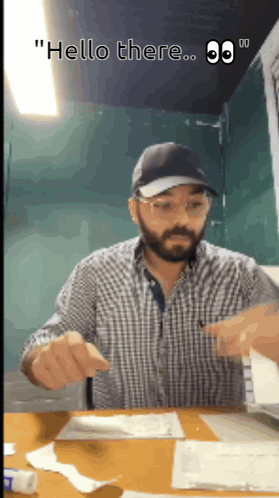 Man Sitting at Desk Saying Hello There