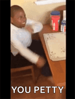 Man Sitting at Desk Saying You Petty