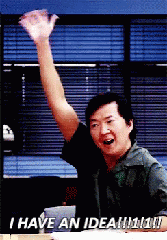 Man Sitting at Desk With Arm in Air