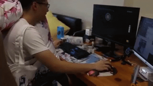 Man Sitting at Desk With Computer Monitor