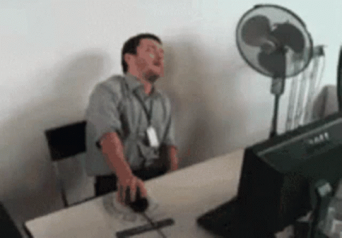 Man Sitting at Desk with Dell Computer Monitor