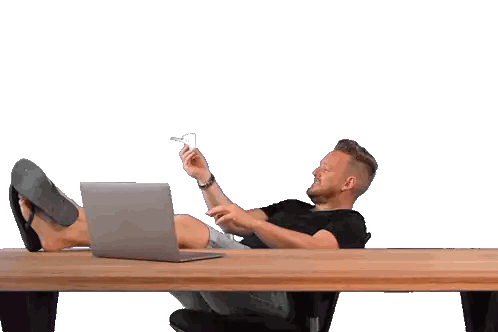 Man Sitting at Desk with Feet Up and Laptop