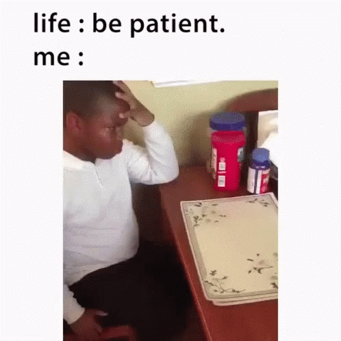 Man Sitting At Desk With Hand On Forehead Saying Life Be Patient Me GIF