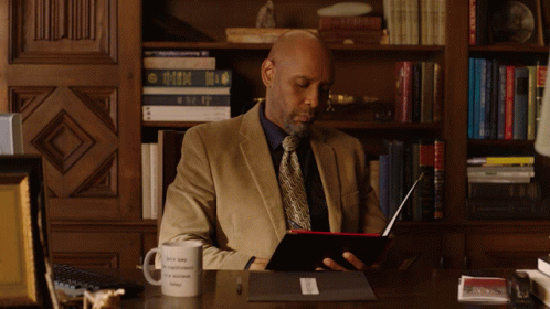 Man Sitting At Desk With Okay To Be Different Mug GIF