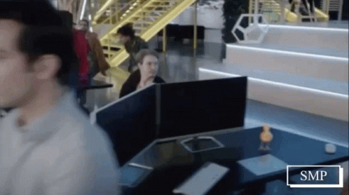 Man Sitting At Desk With SMP Sign GIF