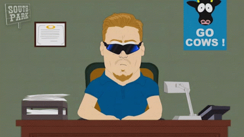 Man Sitting At Desk With South Park Sign GIF