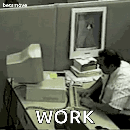 Man Sitting at Desk with Work