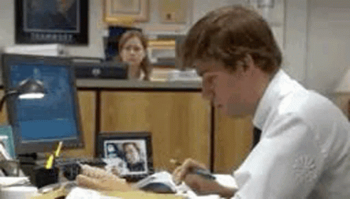Man Sitting at Desk Writing