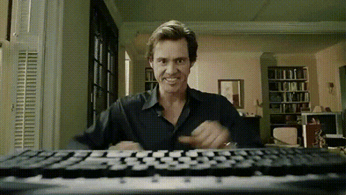 Man Sitting at Keyboard in Living Room