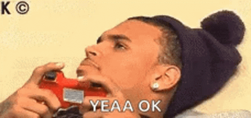 Man Sitting At Table Hand On Chin Saying Yeah Okay GIF