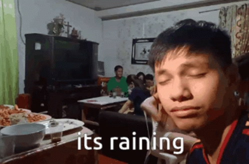 Man Sitting At Table Saying It's Raining GIF