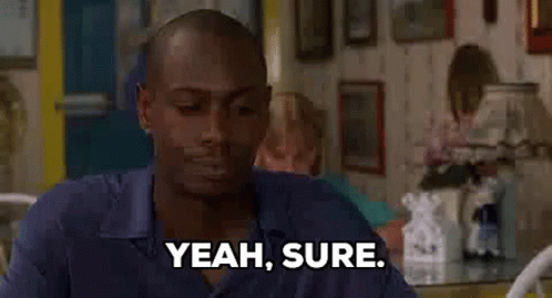Man Sitting At Table Saying Yeah Sure GIF
