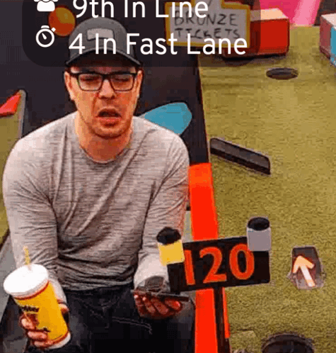 Man Sitting at Table with 120 Sign
