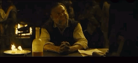 Man Sitting at Table With Beer and Food