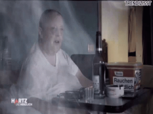 Man Sitting at Table With Beer and Marlboro Cigarettes