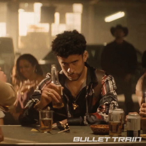 Man Sitting at Table with Bullet Train