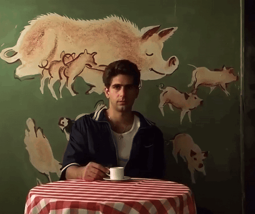 Man Sitting at Table with Coffee