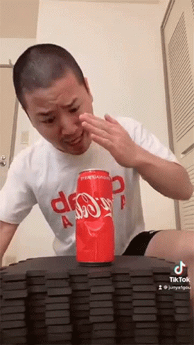 Man Sitting at Table With Dominoes and Coca-Cola