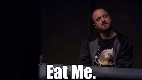 Man Sitting at Table with Eat Me