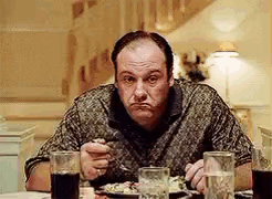 Man Sitting At Table With Food And Soda GIF